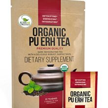 A steaming cup of Organic Pu-Erh Tea with bold, earthy tones, surrounded by fresh tea leaves and a cozy kitchen setting. 