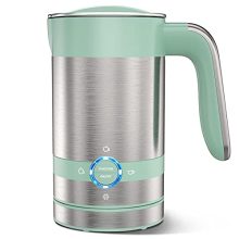 Stainless steel milk frother with detachable base and velvety milk foam inside, perfect for café-style drinks. 
