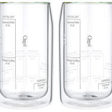 Set of two Ozeri Moderna 15oz double-wall coffee glasses with measurement lines, beautifully displayed on a kitchen counter