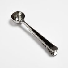 Fox Run stainless steel coffee spoon with clip, 1 tablespoon capacity, used for measuring coffee and sealing bags for freshness.