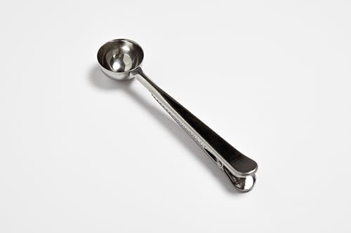 Fox Run stainless steel coffee spoon with clip, 1 tablespoon capacity, used for measuring coffee and sealing bags for freshness.