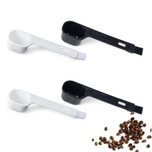 Set of 4 BPA-free 2 Tbsp coffee scoops with long-handled brushes for easy cleaning and precise measuring in a café or home kitchen