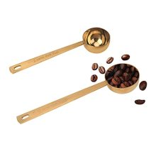 Gold stainless steel coffee scoop set featuring 1-tablespoon and 2-tablespoon measuring spoons, designed for precise measurement of coffee grounds, powders, and spices.