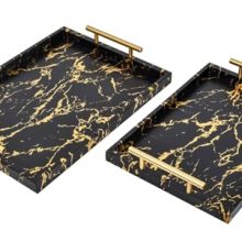 Set of 2 decorative wooden trays with black and gold marble finish, featuring polished metal handles. Ideal for coffee tables, ottomans, and decorative displays. Includes large and small sizes