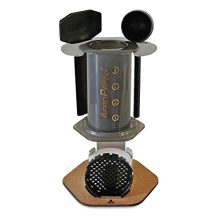 Stainless steel coffee caddy and organizer with cork pad, designed to hold AeroPress® Coffee Maker and accessories neatly on the countertop.