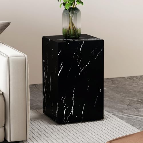 Small black faux marble coffee table with a sleek design, fully assembled, set in a modern living room setting.