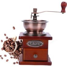 Compact 17ml manual coffee grinder made of pine wood and cast iron with a classic hand-crank design, perfect for home use and travel