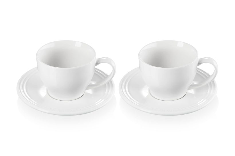 Le Creuset set of 2 white cappuccino cups and saucers made of durable stoneware, featuring a scratch-resistant enamel and 7oz capacity. 