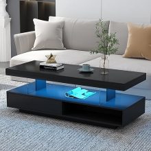 Modern LED coffee table with high gloss finish, featuring 16 color options and 6 brightness settings. Includes storage drawers and open cubbies for a stylish and functional centerpiece in a living room.