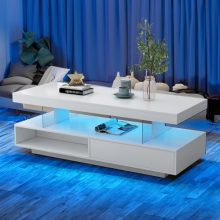 Modern LED coffee table in high gloss white with 16 color options, dynamic lighting modes, open display shelf, and two sliding drawers. Ideal for enhancing living room decor and functionality.