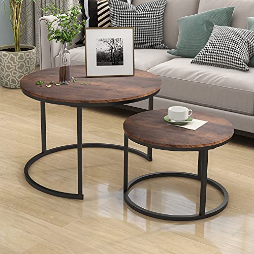 Industrial round coffee table set with a wood-look surface and metal frame, including one large and one small table, placed in a modern living room.