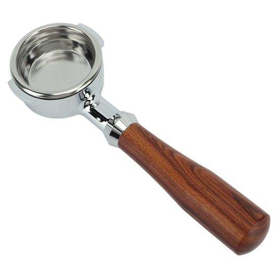 Close-up of a sleek, aluminum 58mm bottomless portafilter placed on a wooden counter, showing off its stainless steel filter basket and ergonomic handle