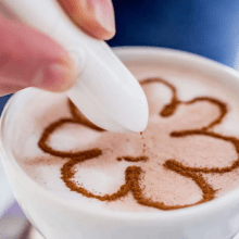 Electric latte art pen in white for easy coffee and cake decoration, with button-operated design.