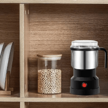 A compact, stainless steel electric coffee bean grinder with a sleek design, perfect for grinding coffee beans, spices, herbs, and nuts in any kitchen.